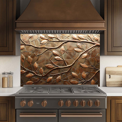 Stainless steel stove with decorative copper leaf glass backsplash in a kitchen setting