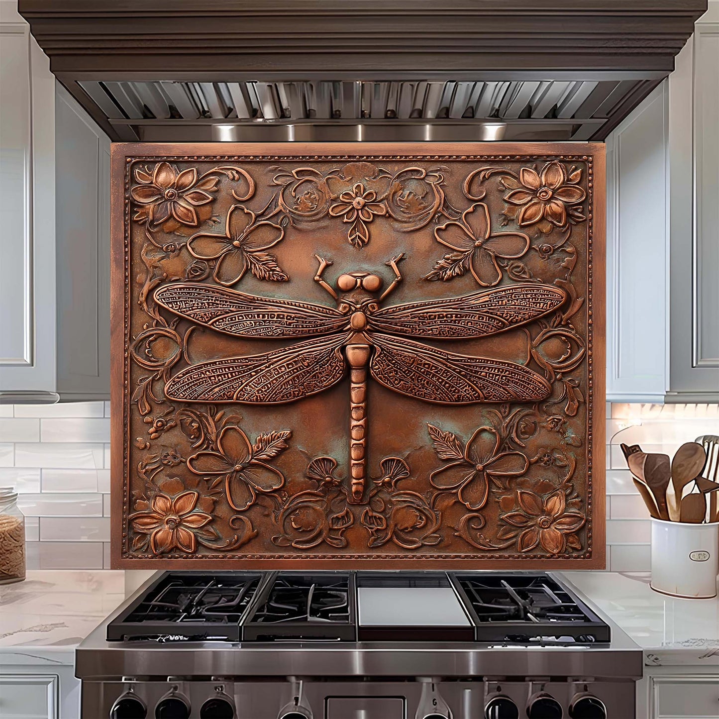 Decorative copper look glass backsplash with floral and dragonfly design above a stove.