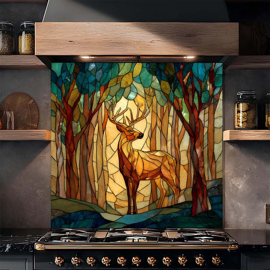Decorative glass backsplash with a deer in a forest design above a stove in a kitchen.