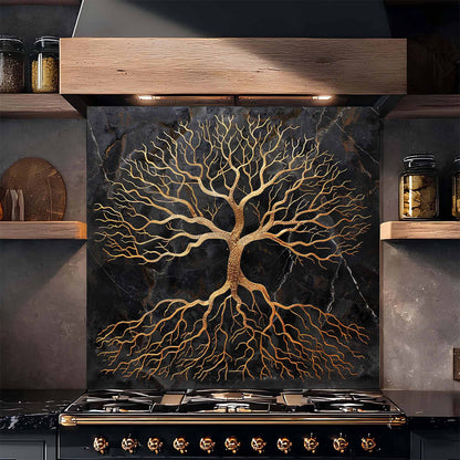 Stainless steel stove with decorative backsplash featuring a tree design in a kitchen setting.