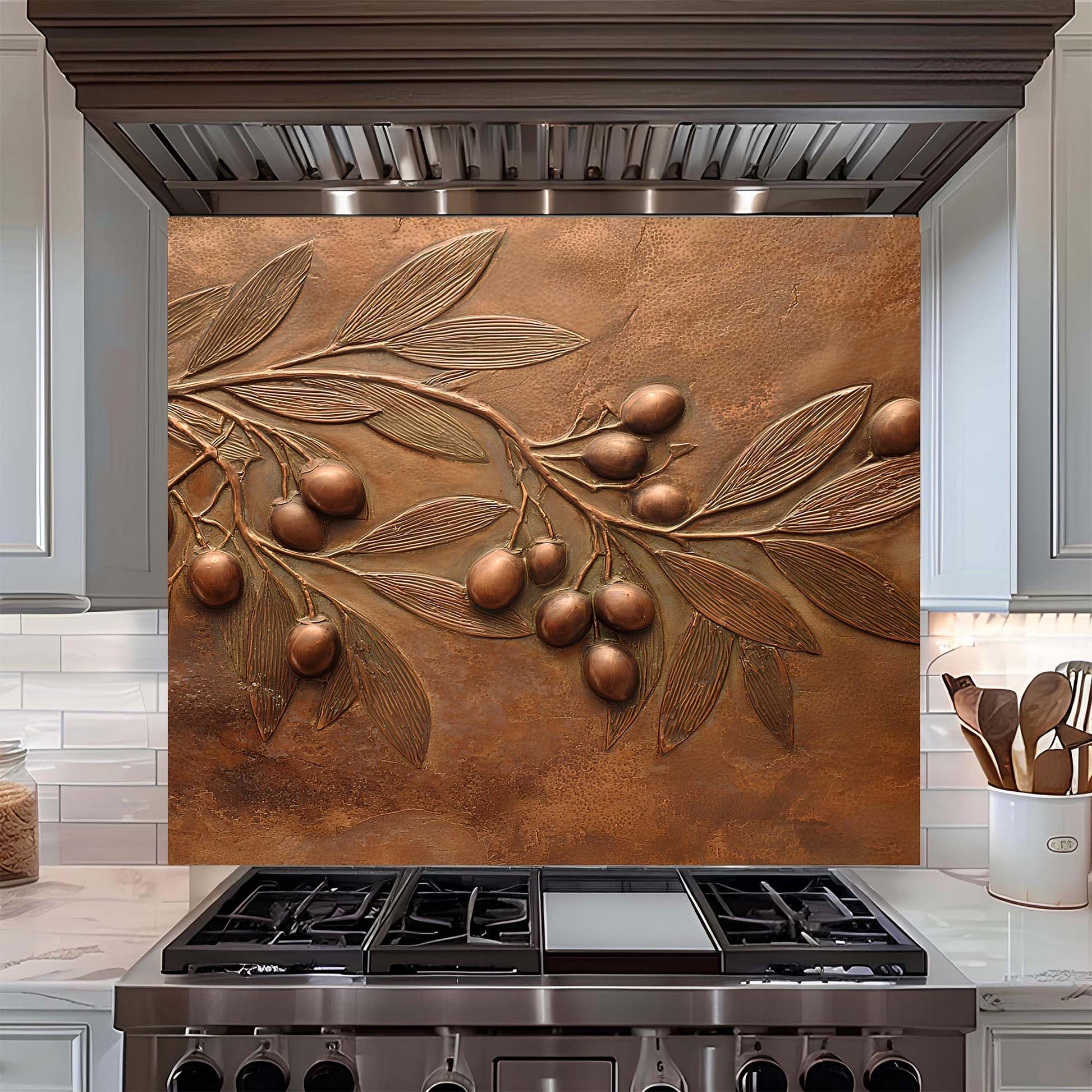 Decorative copper look glass backsplash with olive branch design above a stove in a kitchen.