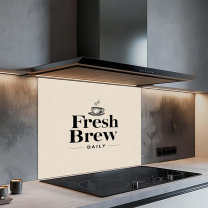 Modern kitchen with a stove and glass splashback featuring 'Fresh Brew Daily' text.