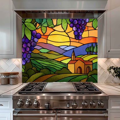 Stainless steel oven with a colorful stained glass-style backsplash depicting a landscape.