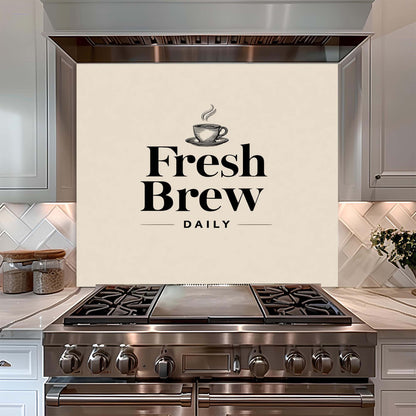 Stainless steel stove with 'Fresh Brew Daily' glass backsplash in a kitchen setting