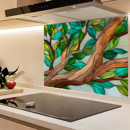 Kitchen with a decorative glass splashback featuring a tree design.