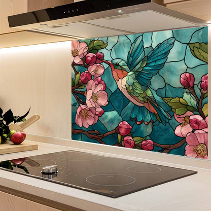 Kitchen backsplash with a colorful hummingbird and floral design.