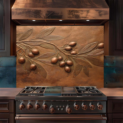 Stainless steel stove with embossed copper look featuring leaves and olives on a backsplash.