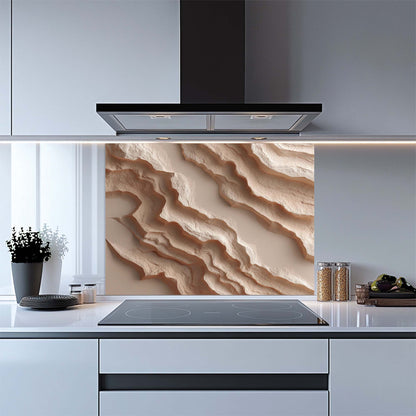 Modern kitchen with a decorative glass backsplash featuring wavy beige patterns.