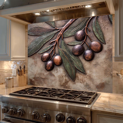 Decorative glass backsplash with metal olive branch design above a stove in a kitchen.