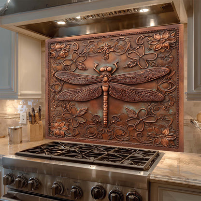 Decorative copper look glass backsplash with a dragonfly design above a stove in a kitchen.
